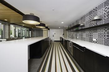 a long corridor with white countertops and black and white patterned wallpaper at The Shay, Washington, DC 20001